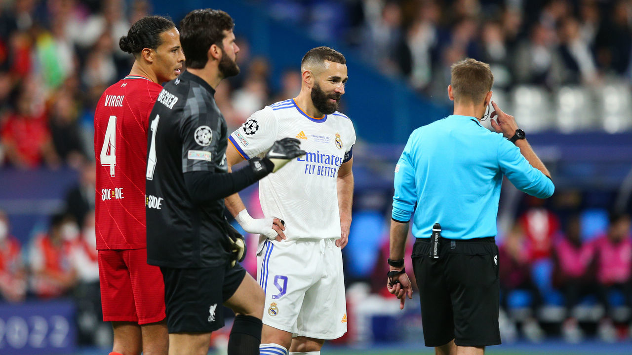 PARIS, FRANCE - MAY 28: Karim Benzema of Real Madrid speaks to Referee Clement Turpin as they await a VAR decision during the UEFA Champions League final match between Liverpool FC and Real Madrid at Stade de France on May 28, 2022 in Paris, France.