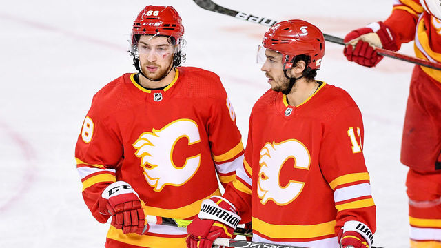 CALGARY, AB - APRIL 26: Calgary Flames Left Wing Andrew Mangiapane (88) and Calgary Flames Left Wing Johnny Gaudreau (13) get ready for a face-off during the second period of an NHL game where the Calgary Flames hosted the Montreal Canadiens on April 26, 2021, at the Scotiabank Saddledome in Calgary, AB.