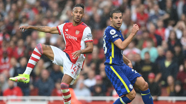 LONDON, ENGLAND - AUGUST 22: Pierre-Emerick Aubameyang of Arsenal shoots as Cesar Azpilicueta of Chelsea looks on during the Premier League match between Arsenal and Chelsea at Emirates Stadium on August 22, 2021 in London, England.