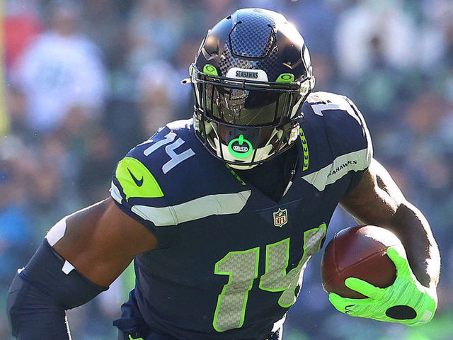 SEATTLE, WASHINGTON - OCTOBER 31: DK Metcalf #14 of the Seattle Seahawks runs with the ball against the Jacksonville Jaguars during the second quarter at Lumen Field on October 31, 2021 in Seattle, Washington.