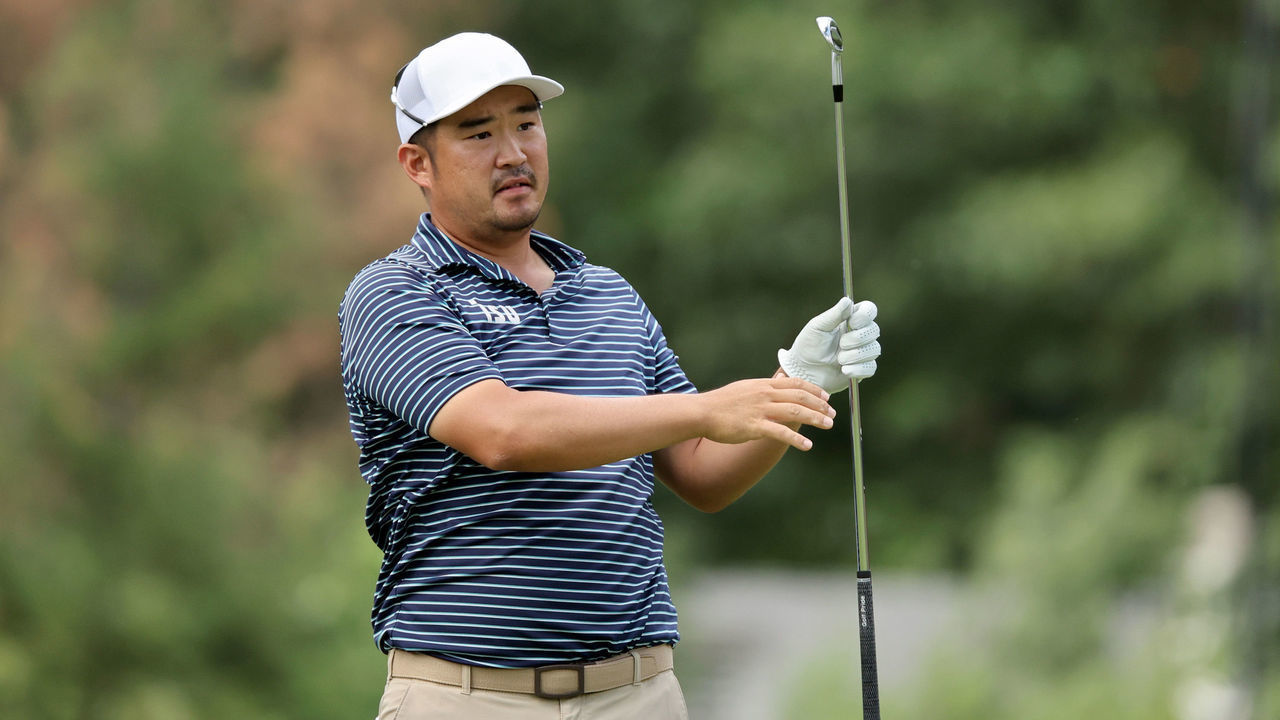 DETROIT, MICHIGAN - JULY 29: John Huh of the United States follows his shot from the ninth tee during the second round of the Rocket Mortgage Classic at Detroit Golf Club on July 29, 2022 in Detroit, Michigan.