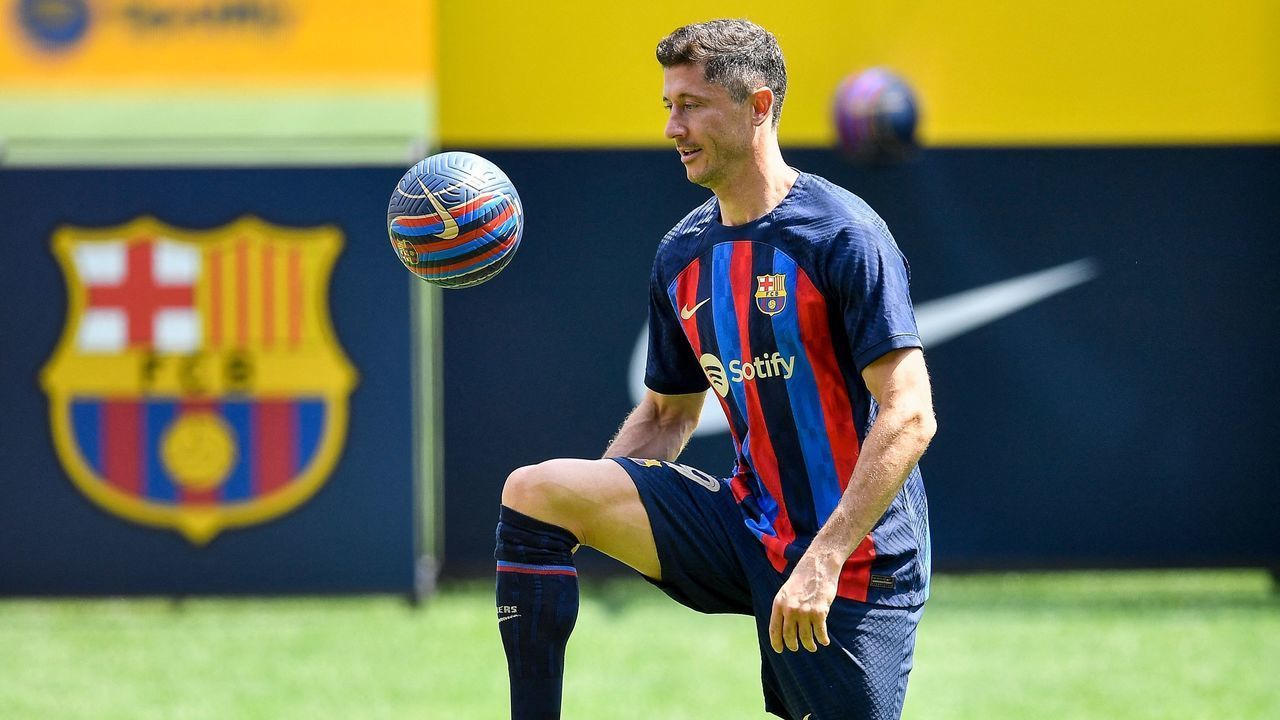 FC Barcelona's Polish forward Robert Lewandowski controls the ball as he poses for pictures during his official presentation at the Camp Nou stadium in Barcelona on August 5, 2022.