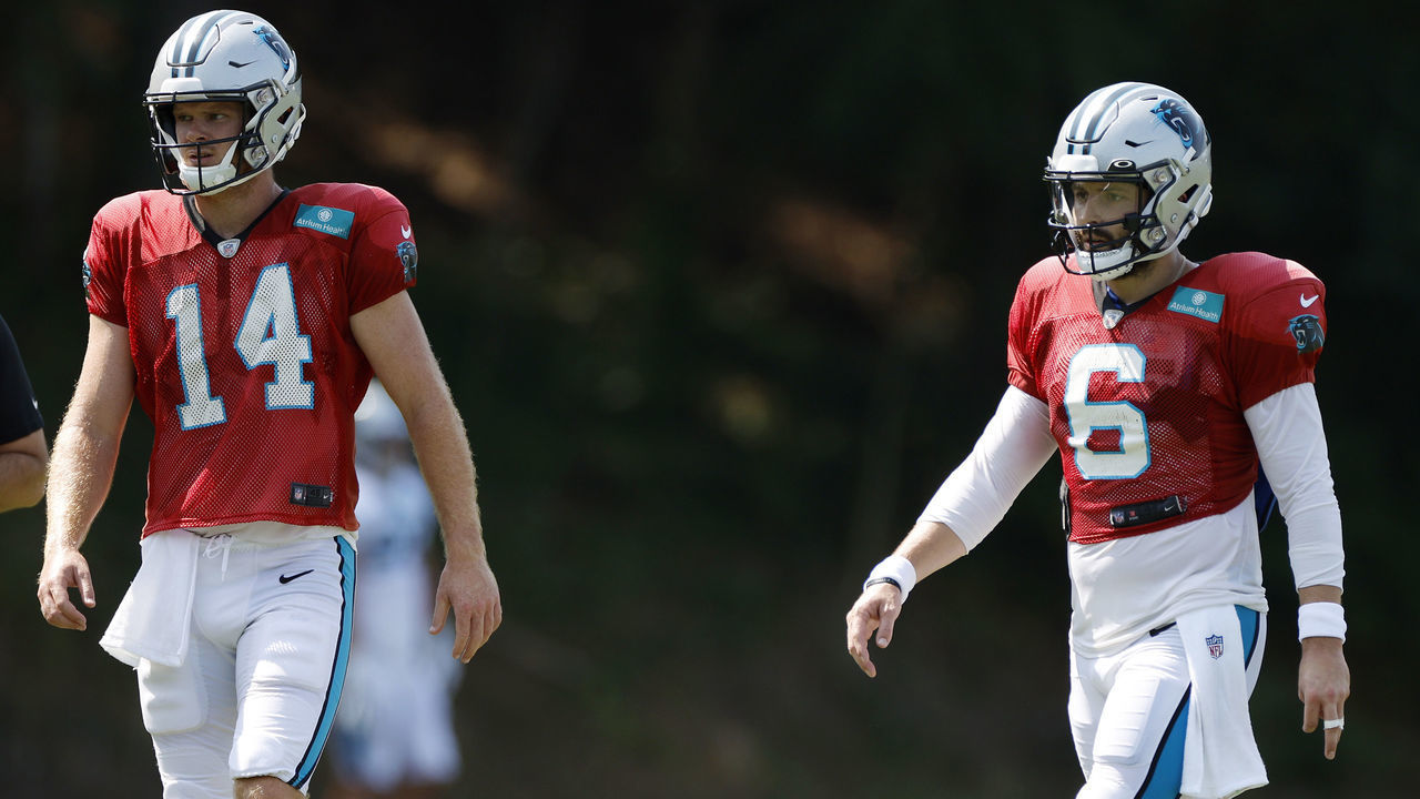 SPARTANBURG, SOUTH CAROLINA - AUGUST 02: Sam Darnold #14 and Baker Mayfield #6 of the Carolina Panthers walk the field during training camp at Wofford College on August 02, 2022 in Spartanburg, South Carolina.