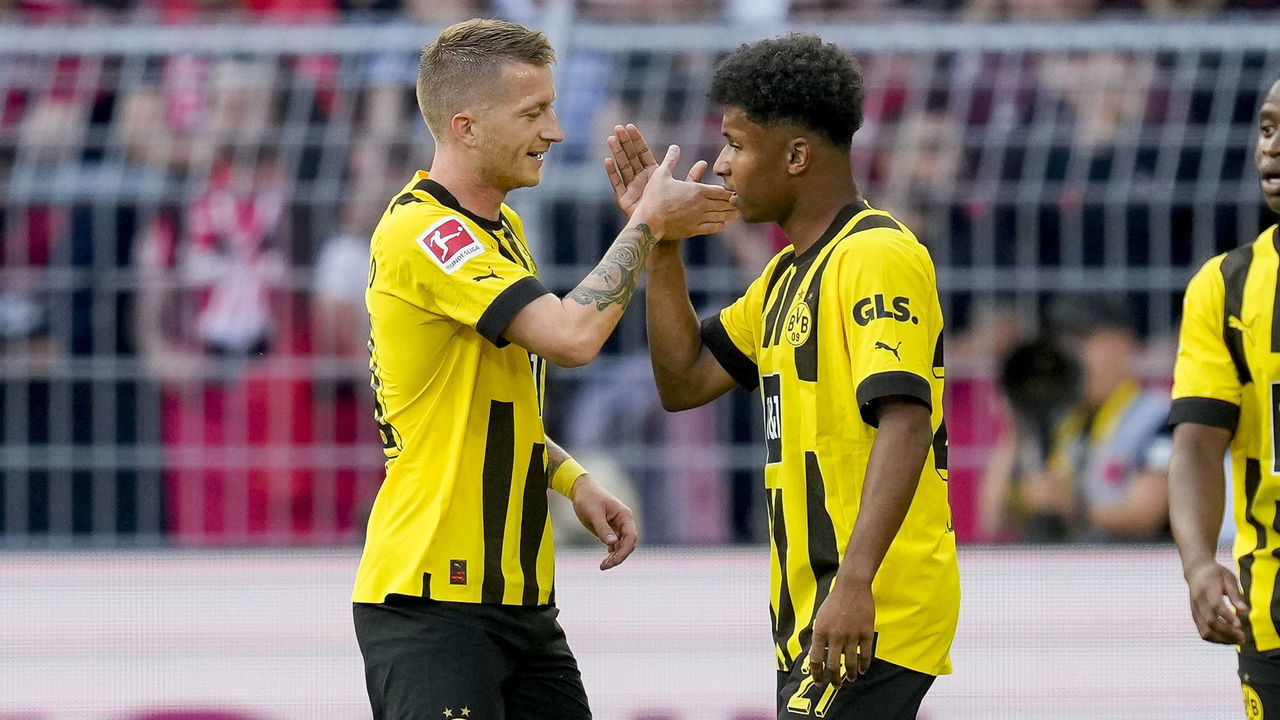 DORTMUND, GERMANY - AUGUST 06: Karim Adeyemi of Borussia Dortmund celebrates after scoring his team's first goal with Marco Reus of Borussia Dortmund during the Bundesliga match between Borussia Dortmund and Bayer 04 Leverkusen at Signal Iduna Park on August 6, 2022 in Dortmund, Germany.