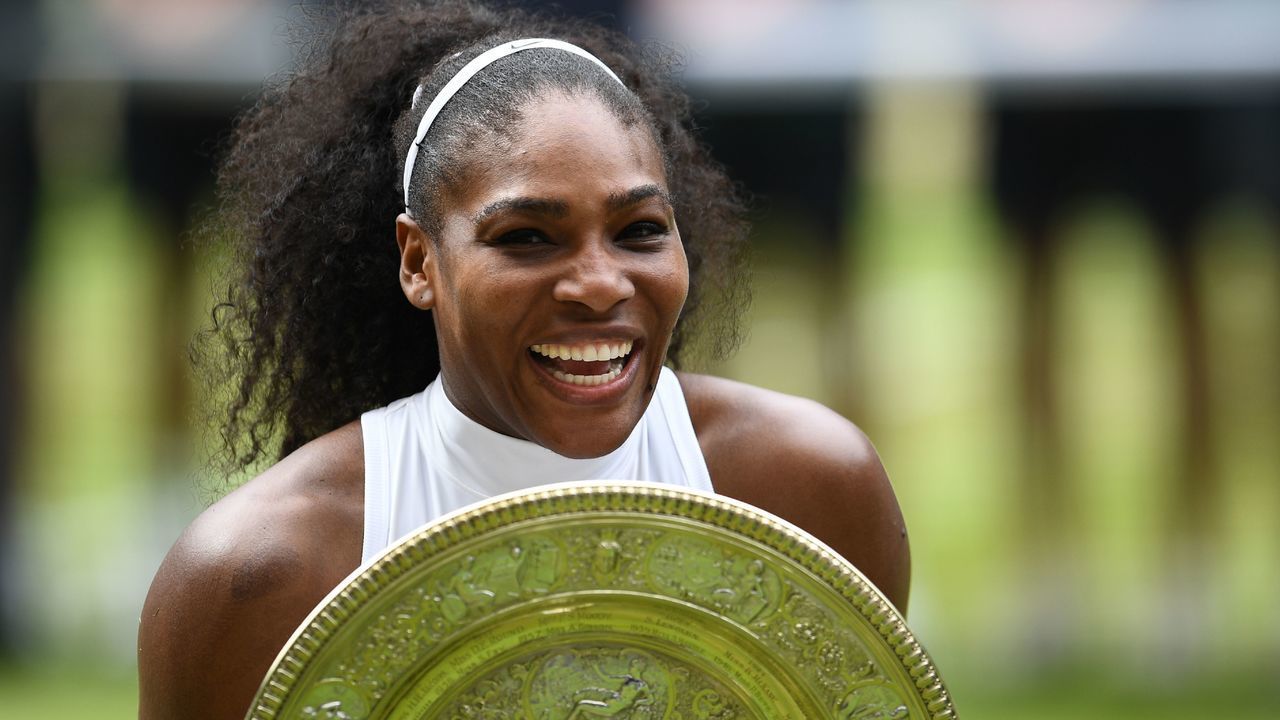 TOPSHOT - US player Serena Williams poses with the winner's trophy, the Venus Rosewater Dish, after her women's singles final victory over Germany's Angelique Kerber on the thirteenth day of the 2016 Wimbledon Championships at The All England Lawn Tennis Club in Wimbledon, southwest London, on July 9, 2016. / AFP PHOTO / GLYN KIRK / RESTRICTED TO EDITORIAL USE