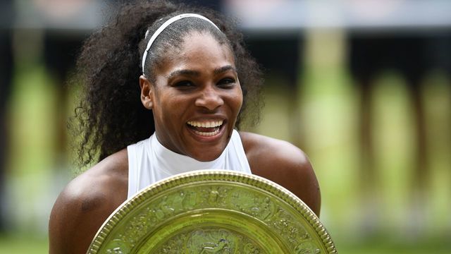 TOPSHOT - US player Serena Williams poses with the winner's trophy, the Venus Rosewater Dish, after her women's singles final victory over Germany's Angelique Kerber on the thirteenth day of the 2016 Wimbledon Championships at The All England Lawn Tennis Club in Wimbledon, southwest London, on July 9, 2016. / AFP PHOTO / GLYN KIRK / RESTRICTED TO EDITORIAL USE