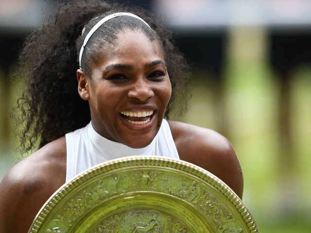 TOPSHOT - US player Serena Williams poses with the winner's trophy, the Venus Rosewater Dish, after her women's singles final victory over Germany's Angelique Kerber on the thirteenth day of the 2016 Wimbledon Championships at The All England Lawn Tennis Club in Wimbledon, southwest London, on July 9, 2016. / AFP PHOTO / GLYN KIRK / RESTRICTED TO EDITORIAL USE