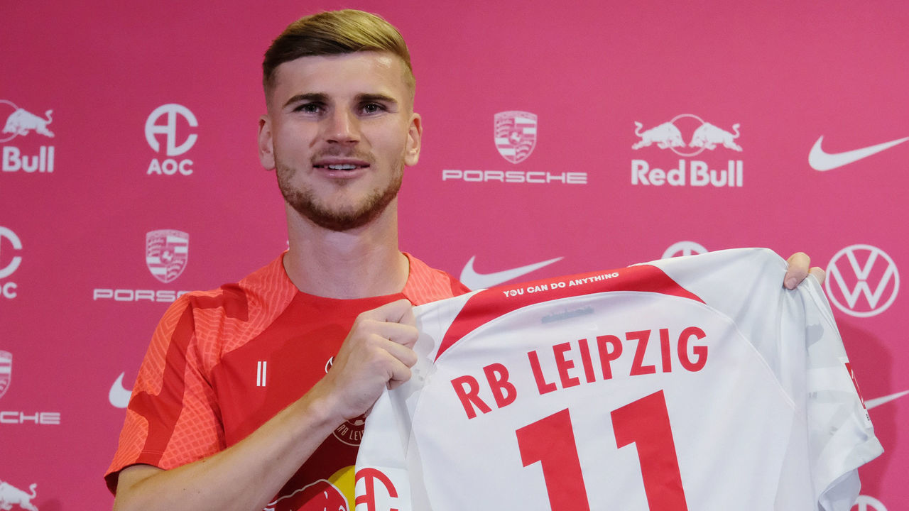 10 August 2022, Saxony, Leipzig: Timo Werner, RB Leipzig soccer player again, holds his jersey during a press conference. He moved from Chelsea FC back to RB Leipzig. Photo: Sebastian Willnow/dpa