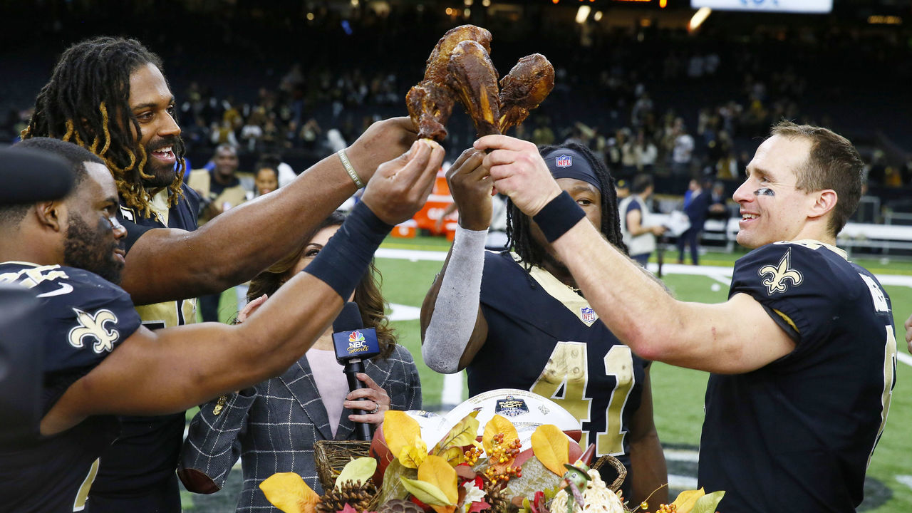 Football: New Orleans Saints Alvin Kamara (41), QB Drew Brees (9), Sheldon Rankins (98) and Cameron Jordan (94) victorious, saluting with turkey drumsticks after game vs Atlanta Falcons at Mercedes-Benz Superdome. Brees, Kamara, Rankins and Jordan with Thanksgiving dinner. New Orleans, LA 11/22/2018 CREDIT: David E. Klutho (Set Number: X162344 TK1 )