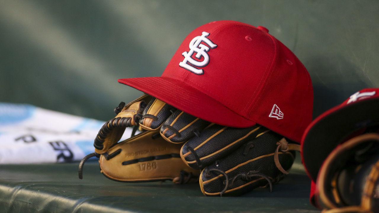 ATLANTA, GA - JULY 06: A detailed view of a St. Louis Cardinals hat and glove in the dugout against the Atlanta Braves in the fifth inning at Truist Park on July 6, 2022 in Atlanta, Georgia.
