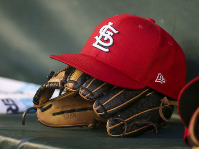 ATLANTA, GA - JULY 06: A detailed view of a St. Louis Cardinals hat and glove in the dugout against the Atlanta Braves in the fifth inning at Truist Park on July 6, 2022 in Atlanta, Georgia.