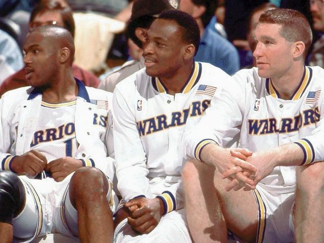 OAKLAND, CA - 1989: (L) Tim Hardaway #10, (C) Mitch Richmond #23 and (R) Chris Mullin #17 of the Golden State Warriors sit on the bench during a game played in 1989 at the Oakland-Alameda Coliseum in Oakland, California. NOTE TO USER: User expressly acknowledges that, by downloading and or using this photograph, User is consenting to the terms and conditions of the Getty Images License agreement. Mandatory Copyright Notice: Copyright 1989 NBAE