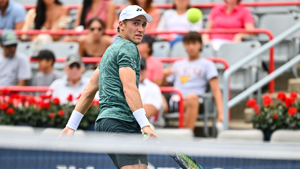 MONTREAL, QUEBEC - AUGUST 11: Casper Ruud of Norway hits a backhanded return against Roberto Bautista Agut of Spain during Day 6 of the National Bank Open at Stade IGA on August 11, 2022 in Montreal, Canada.