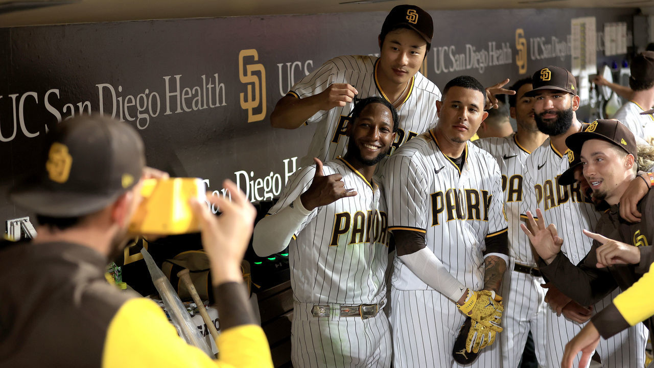 SAN DIEGO, CALIFORNIA - AUGUST 09: Joe Musgrove #44 takes a photo of Jurickson Profar #10, Ha-Seong Kim #7, Blake Snell #4 Luis Garcia #66 and Manny Machado #13 of the San Diego Padres after defeating the San Francisco Giants 7-4 in a game at PETCO Park on August 09, 2022 in San Diego, California.