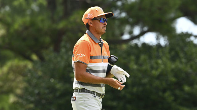 MEMPHIS, TENNESSEE - AUGUST 14: Rickie Fowler removes his glove while leaving the 17th hole during the final round of the FedEx St. Jude Championship at TPC Southwind on August 14, 2022 in Memphis, Tennessee.