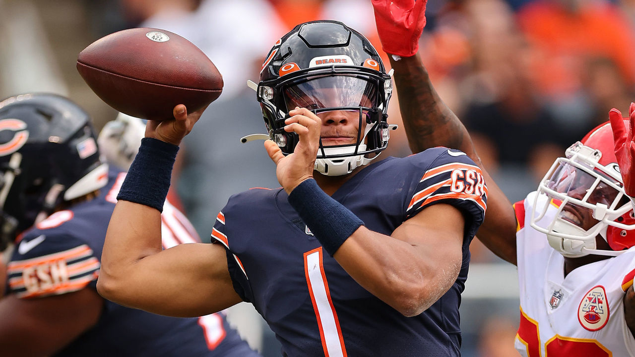 CHICAGO, ILLINOIS - AUGUST 13: Justin Fields #1 of the Chicago Bears throws a pass under pressure from Deon Bush #26 of the Kansas City Chiefs during the first half of the preseason game at Soldier Field on August 13, 2022 in Chicago, Illinois.