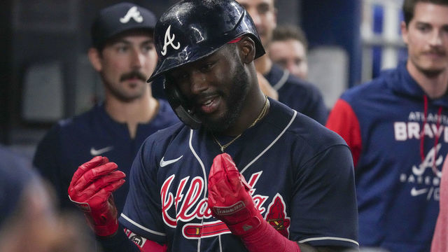 MIAMI, FLORIDA - AUGUST 14: Michael Harris II #23 of the Atlanta Braves celebrates in the dugout with teammates after hitting a home run in the ninth inning against the Miami Marlins at loanDepot park on August 14, 2022 in Miami, Florida.