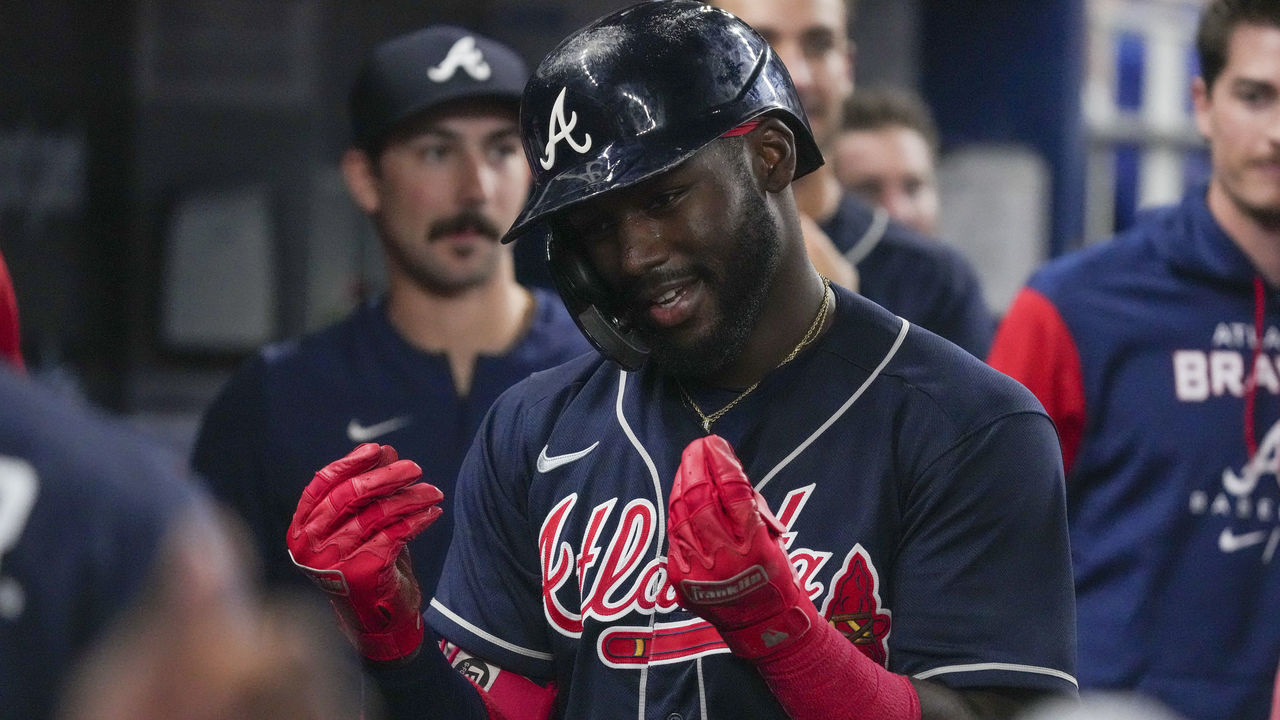 MIAMI, FLORIDA - AUGUST 14: Michael Harris II #23 of the Atlanta Braves celebrates in the dugout with teammates after hitting a home run in the ninth inning against the Miami Marlins at loanDepot park on August 14, 2022 in Miami, Florida.