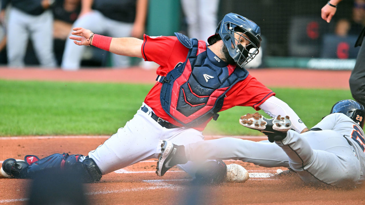 CLEVELAND, OHIO - AUGUST 16: Javier Baez #28 of the Detroit Tigers scores against catcher Austin Hedges #17 of the Cleveland Guardians in the first inning at Progressive Field on August 16, 2022 in Cleveland, Ohio.