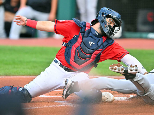 CLEVELAND, OHIO - AUGUST 16: Javier Baez #28 of the Detroit Tigers scores against catcher Austin Hedges #17 of the Cleveland Guardians in the first inning at Progressive Field on August 16, 2022 in Cleveland, Ohio.