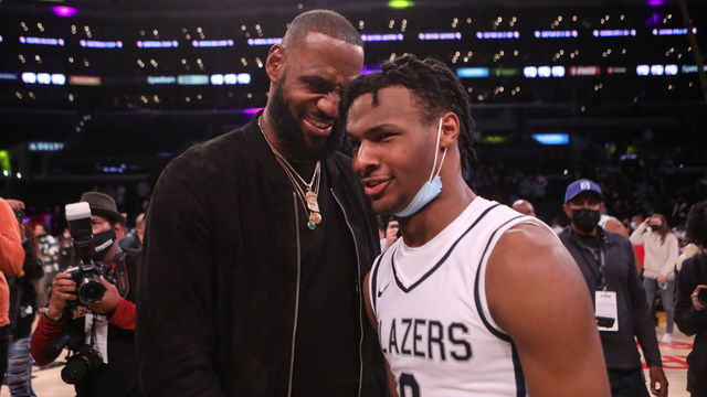 LOS ANGELES, CA - DECEMBER 04: Lebron James comes onto the court to congratulate his son Bronny James (0) point guard for Sierra Canyon after his team won against St. Vincent-St. Mary during The Chosen - 1's Invitational High School Basketball Showcase at the Staples Center on Saturday, Dec. 4, 2021 in Los Angeles, CA. (Jason Armond / Los Angeles Times via Getty Images)