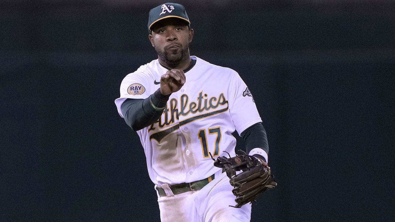 OAKLAND, CALIFORNIA - AUGUST 08: Elvis Andrus #17 of the Oakland Athletics throws to first base off balance to throw out Max Stassi #33 of the Los Angeles Angels in the top of the seventh inning at RingCentral Coliseum on August 08, 2022 in Oakland, California.