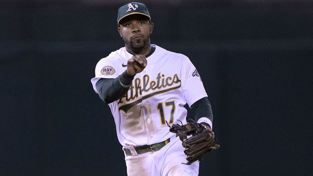 OAKLAND, CALIFORNIA - AUGUST 08: Elvis Andrus #17 of the Oakland Athletics throws to first base off balance to throw out Max Stassi #33 of the Los Angeles Angels in the top of the seventh inning at RingCentral Coliseum on August 08, 2022 in Oakland, California.