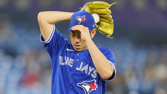 TORONTO, ON - AUGUST 15: Yusei Kikuchi #16 of the Toronto Blue Jays fixes his cap in a break in play against the Baltimore Orioles in the fourth inning during their MLB game at the Rogers Centre on August 15, 2022 in Toronto, Ontario, Canada.