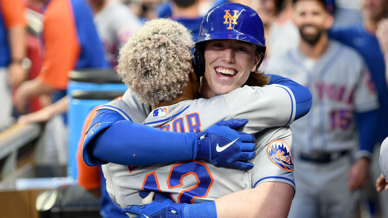 ATLANTA, GA - AUGUST 17: Brett Baty #22 of the New York Mets hugs Francisco Lindor #12 of the New York Mets after hitting his first home run during his first MLB at bat against the Atlanta Braves in the second inning at Truist Park on August 17, 2022 in Atlanta, Georgia.