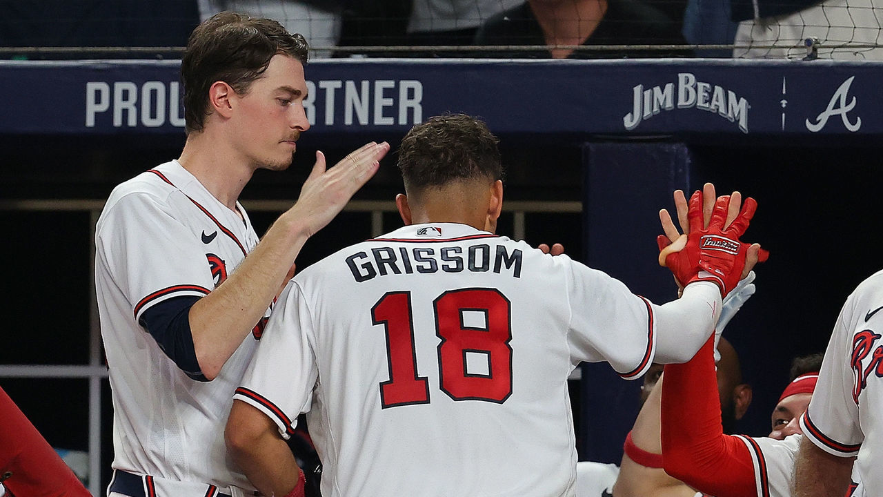 ATLANTA, GEORGIA - AUGUST 18: Vaughn Grissom #18 of the Atlanta Braves reacts with Max Fried #54 after scoring the go-ahead run on a double by Michael Harris II #23 in the seventh inning against the New York Mets at Truist Park on August 18, 2022 in Atlanta, Georgia.