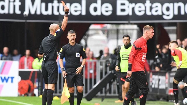 Rennes' French goalkeeper Romain Salin (R) receives a red card from French referee Hakim Ben El Hadj Salem during the French L1 football match between Stade Rennais FC and AC Ajaccio at The Roazhon Park Stadium in Rennes, western France on August 21, 2022.