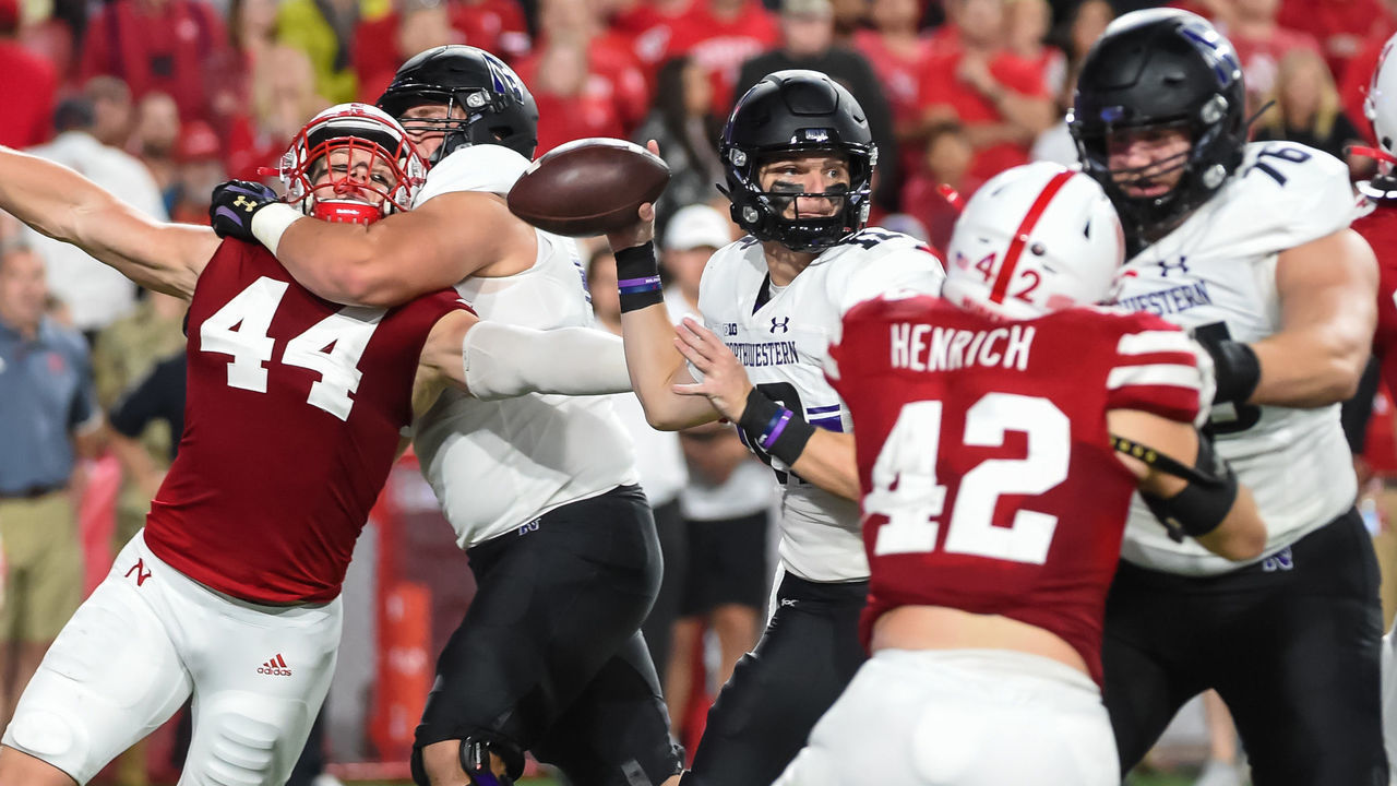 LINCOLN, NE - OCTOBER 2: Quarterback Ryan Hilinski #12 of the Northwestern Wildcats passes against a rush from linebacker Garrett Nelson #44 and linebacker Nick Henrich #42 of the Nebraska Cornhuskers in the second half at Memorial Stadium on October 2, 2021 in Lincoln, Nebraska.