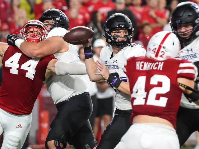 LINCOLN, NE - OCTOBER 2: Quarterback Ryan Hilinski #12 of the Northwestern Wildcats passes against a rush from linebacker Garrett Nelson #44 and linebacker Nick Henrich #42 of the Nebraska Cornhuskers in the second half at Memorial Stadium on October 2, 2021 in Lincoln, Nebraska.