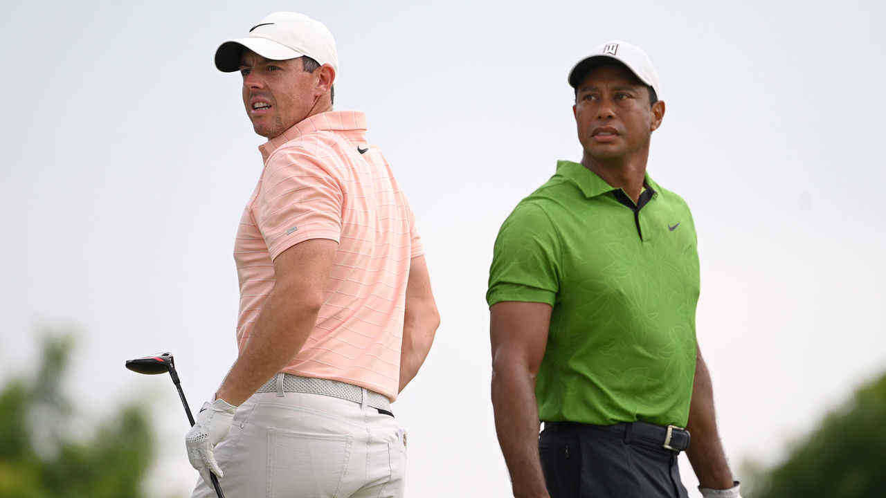TULSA, OKLAHOMA - MAY 20: Rory McIlroy of Northern Ireland and Tiger Woods of the United States watch a tee shot on the 10th tee during the second round of the 2022 PGA Championship at Southern Hills Country Club on May 20, 2022 in Tulsa, Oklahoma.