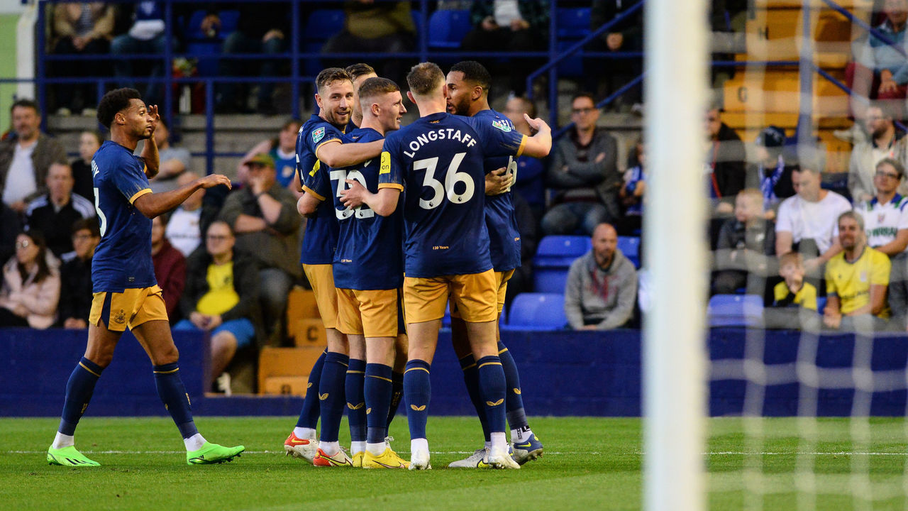 BIRKENHEAD, ENGLAND - AUGUST 24: Jamaal Lascelles of Newcastle United FC (6) celebrates with teammates after scoring the equalising goal during the Carabao Cup Second Round match between Tranmere Rovers and Newcastle United at Prenton Park on August 24, 2022 in Birkenhead, England.