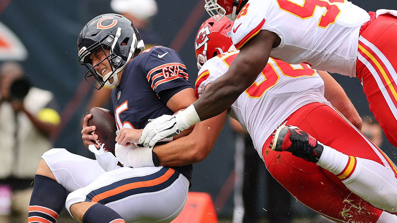 CHICAGO, ILLINOIS - AUGUST 13: Trevor Siemian #15 of the Chicago Bears is sacked by George Karlaftis #56 and Tershawn Wharton #98 of the Kansas City Chiefs during the first half of the preseason game at Soldier Field on August 13, 2022 in Chicago, Illinois.