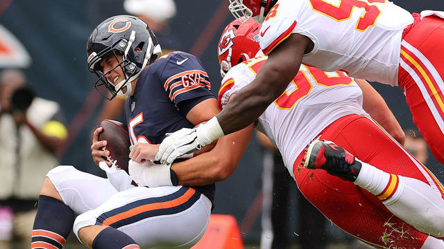 CHICAGO, ILLINOIS - AUGUST 13: Trevor Siemian #15 of the Chicago Bears is sacked by George Karlaftis #56 and Tershawn Wharton #98 of the Kansas City Chiefs during the first half of the preseason game at Soldier Field on August 13, 2022 in Chicago, Illinois.