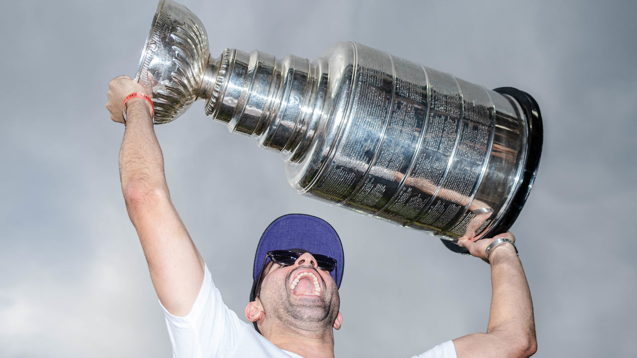 DENVER, COLORADO - JUNE 29: Nazem Kadri #91 of the Colorado Avalanche celebrates with the Stanley Cup prior to the game against the Colorado Rockies and Los Angeles Dodgers at Coors Field on June 29, 2022 in Denver, Colorado.