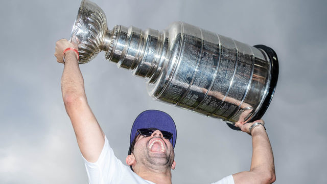DENVER, COLORADO - JUNE 29: Nazem Kadri #91 of the Colorado Avalanche celebrates with the Stanley Cup prior to the game against the Colorado Rockies and Los Angeles Dodgers at Coors Field on June 29, 2022 in Denver, Colorado.