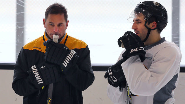 BOSTON - FEBRUARY 8: New Boston Bruins coach Bruce Cassidy, left, has a long chat with Patrice Bergeron during a practice at Warrior Arena in Boston on Feb. 8, 2017.
