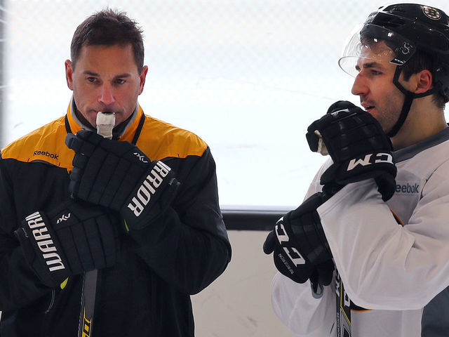 BOSTON - FEBRUARY 8: New Boston Bruins coach Bruce Cassidy, left, has a long chat with Patrice Bergeron during a practice at Warrior Arena in Boston on Feb. 8, 2017.