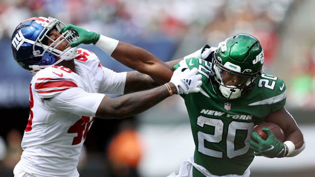 EAST RUTHERFORD, NEW JERSEY - AUGUST 28: Running back Breece Hall #20 of the New York Jets carries the ball as linebacker Tae Crowder #48 of the New York Giants chases during the 1st half of the preseason game at MetLife Stadium on August 28, 2022 in East Rutherford, New Jersey.