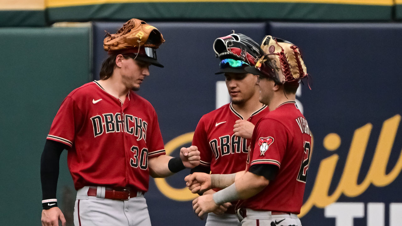 CHICAGO, ILLINOIS - AUGUST 28: Jake McCarthy #30, Alek Thomas #5 and Daulton Varsho #12 of the Arizona Diamondbacks celebrate a 3-2 win against the Chicago White Sox at Guaranteed Rate Field on August 28, 2022 in Chicago, Illinois.