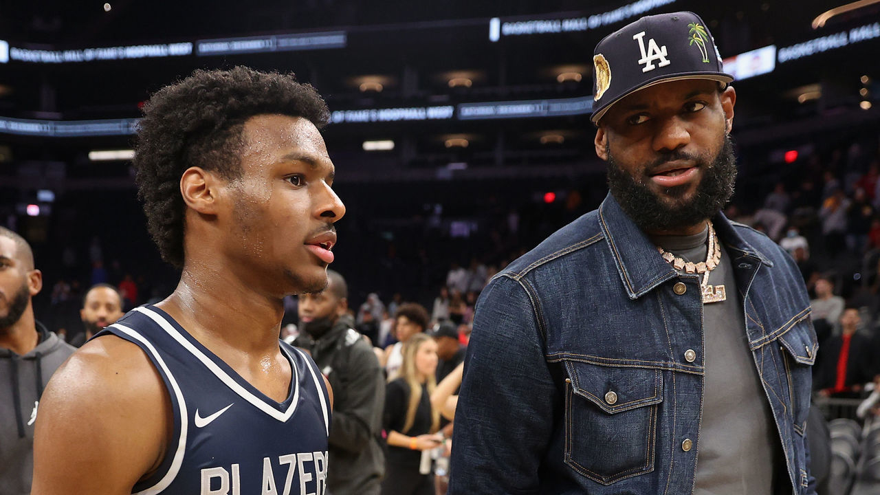 PHOENIX, ARIZONA - DECEMBER 11: Bronny James #0 of the Sierra Canyon Trailblazers and father LeBron James of the Los Angeles Lakers walk off the court following the Hoophall West tournament at Footprint Center on December 11, 2021 in Phoenix, Arizona.