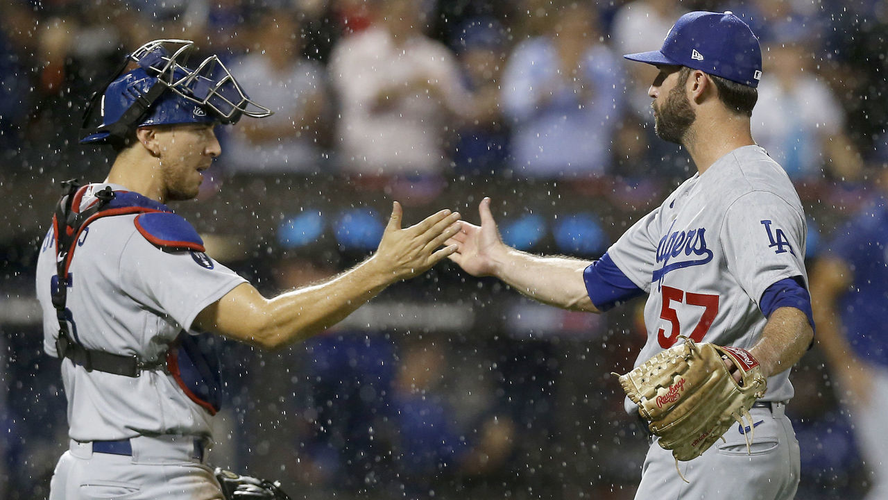 NEW YORK, NEW YORK - AUGUST 30: Jake Reed #57 and Austin Barnes #15 of the Los Angeles Dodgers celebrate after defeating the New York Mets at Citi Field on August 30, 2022 in New York City.