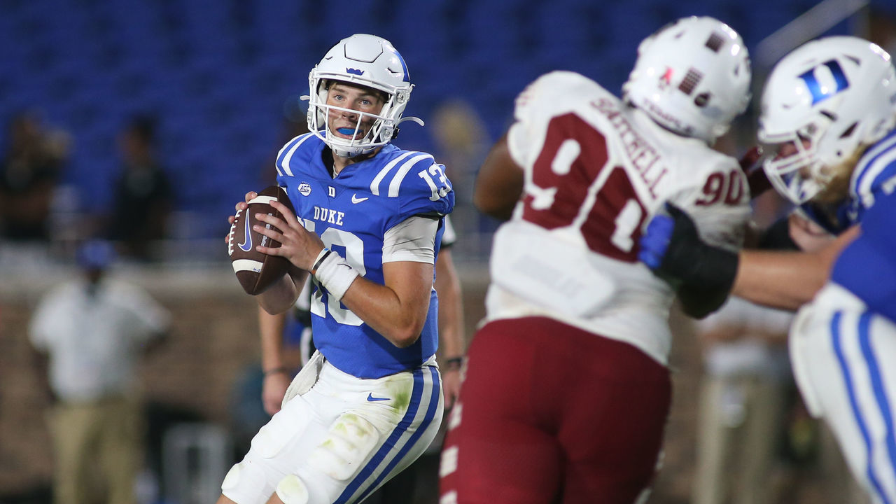 DURHAM, NC - SEPTEMBER 02: Duke Blue Devils quarterback Riley Leonard (13) moves out of the pocket as Temple Owls defensive lineman Jalen Satchell (90) closest in during the college football game between the Duke Blue Devils and the Temple Owls on September 2, 2022, in Wallace Wade Stadium in Durham, NC.