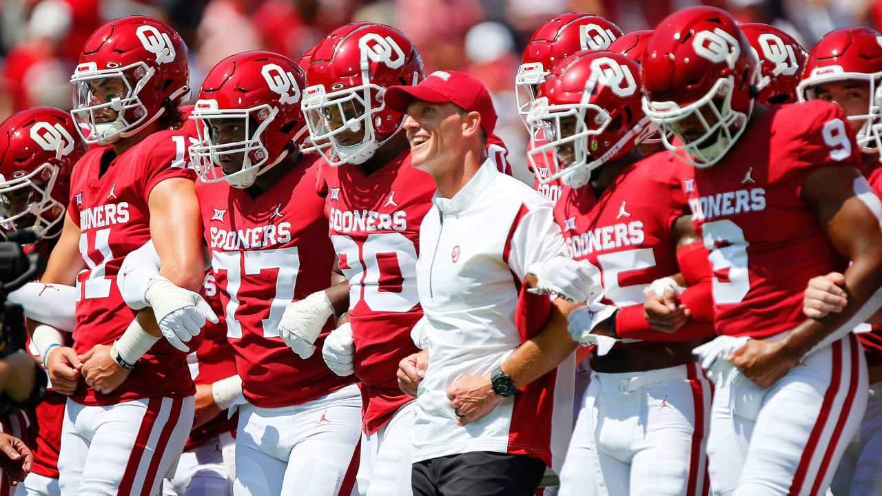 NORMAN, OK - SEPTEMBER 3: Head coach Brent Venables of the Oklahoma Sooners walks arm in arm with his team before a game against the UTEP Miners at Gaylord Family Oklahoma Memorial Stadium on September 3, 2022 in Norman, Oklahoma.