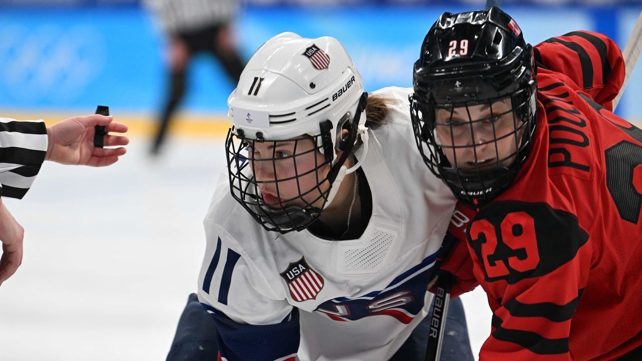 USA's Abby Roque (L) and Canada's Marie-Philip Poulin fight for the puck during the women's gold medal match of the Beijing 2022 Winter Olympic Games ice hockey competition between Canada and USA, at the Wukesong Sports Centre in Beijing on February 17, 2022.