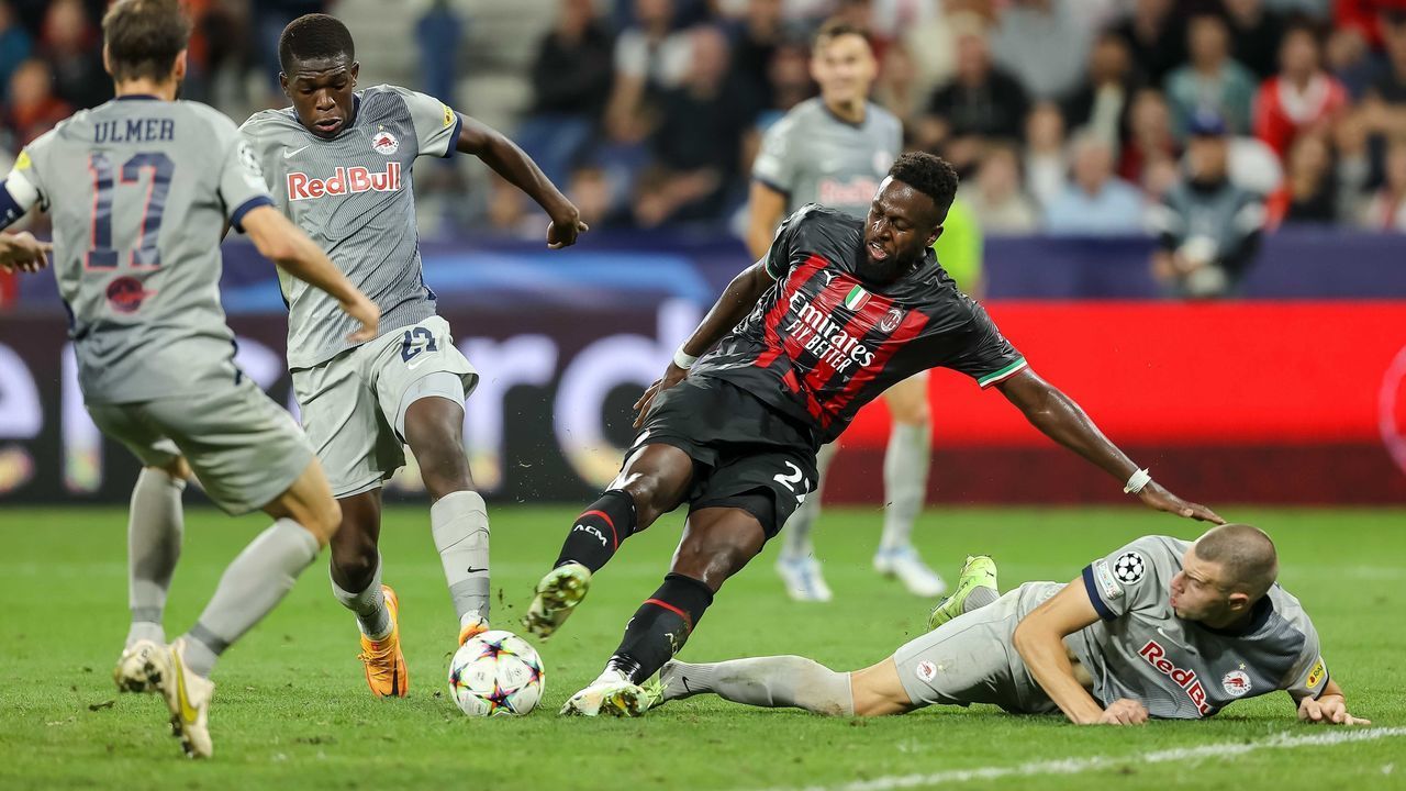 SALZBURG, AUSTRIA - SEPTEMBER 06: Lucas Gourna-Douath of Red Bull Salzburg, Divock Origi of AC Milan and Strahinja Pavlovic of Red Bull Salzburg battle for the ball during the UEFA Champions League group E match between FC Salzburg and AC Milan at Football Arena Salzburg on September 6, 2022 in Salzburg, Austria.