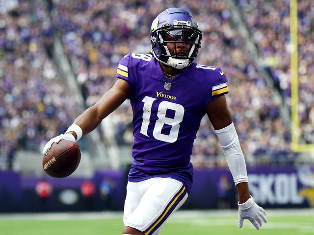MINNEAPOLIS, MINNESOTA - SEPTEMBER 11: Justin Jefferson #18 of the Minnesota Vikings scores a touchdown during the first quarter in the game against the Green Bay Packers at U.S. Bank Stadium on September 11, 2022 in Minneapolis, Minnesota.